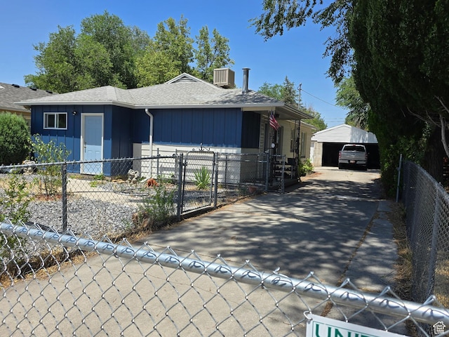 1134 W Illinois Ave S, Salt Lake City, UT 84104 - view of front facade with board and batten siding, roof with shingles, driveway, and a gate