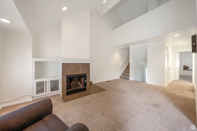 527 Applewood Dr, Bountiful, UT 84010 - living room featuring carpet floors, a tiled fireplace, recessed lighting, stairs, and a high ceiling