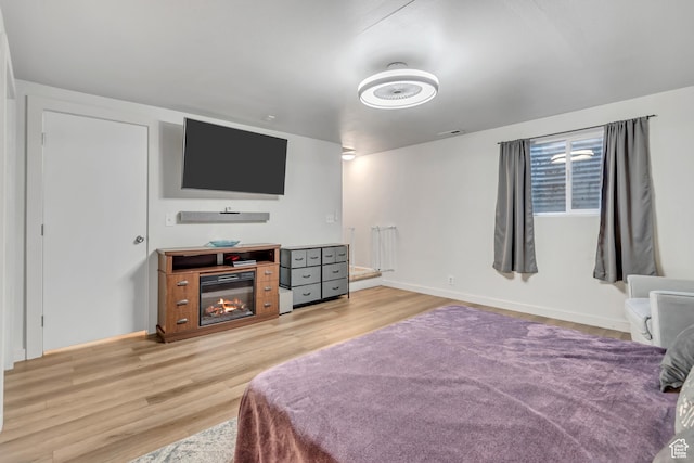 5235 S Glendon St Unit W3, Murray, UT 84123 - bedroom with light wood-type flooring and a glass covered fireplace