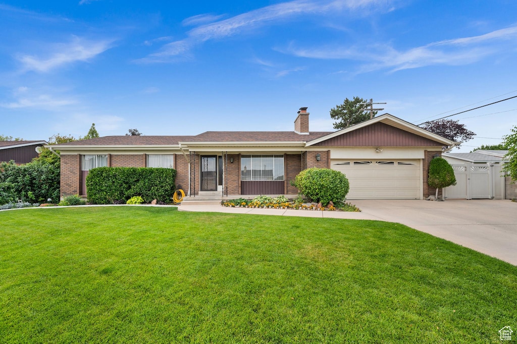 3385 W Meadowbrook Dr W, West Valley City, UT 84119 - ranch-style house with brick siding, a chimney, an attached garage, and concrete driveway