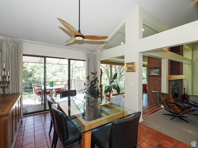 3348 E Splendor Cir, Holladay, UT 84124 - dining area featuring dark tile patterned floors, ceiling fan, a fireplace, and high vaulted ceiling