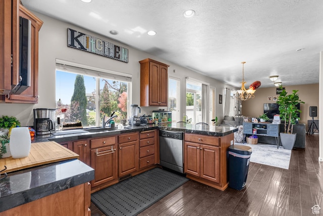 5453 W Mayflower St, West Jordan, UT 84081 - kitchen with stainless steel dishwasher, a chandelier, open floor plan, a peninsula, and brown cabinetry