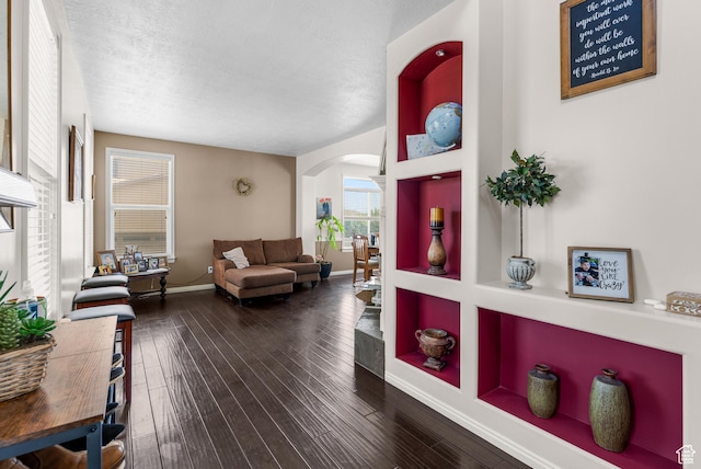 5453 W Mayflower St, West Jordan, UT 84081 - living area with arched walkways, dark wood finished floors, and a textured ceiling