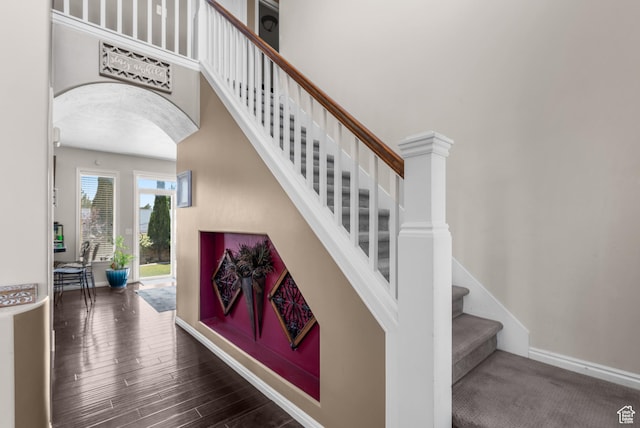 5453 W Mayflower St, West Jordan, UT 84081 - staircase with arched walkways, wood finished floors, and a towering ceiling