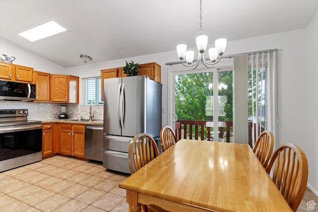 771 N 1725 W, Clinton, UT 84015 - kitchen featuring stainless steel appliances, a chandelier, light countertops, backsplash, and light tile patterned flooring