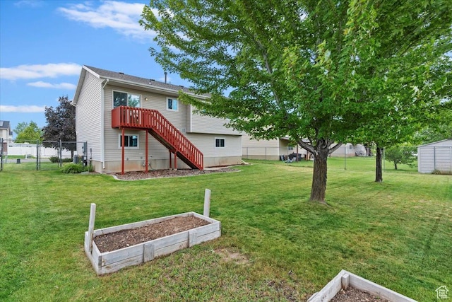 771 N 1725 W, Clinton, UT 84015 - back of house with a garden, stairway, and a wooden deck