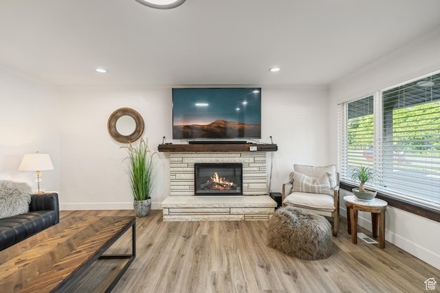 174 W Dawson St, Layton, UT 84041 - living area with a stone fireplace, crown molding, wood finished floors, and recessed lighting