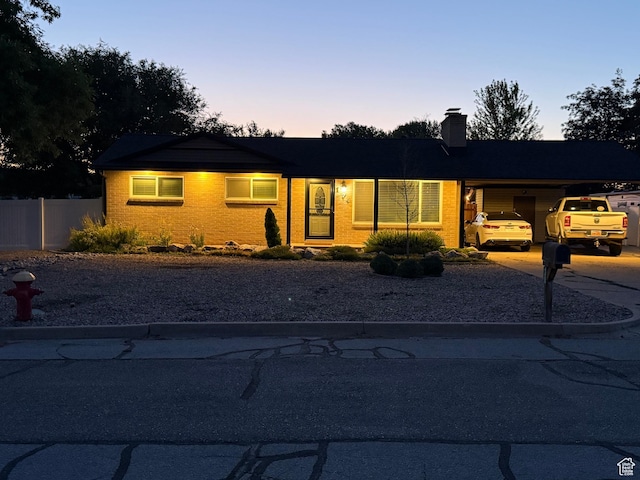 174 W Dawson St, Layton, UT 84041 - single story home featuring concrete driveway, a chimney, a carport, and brick siding