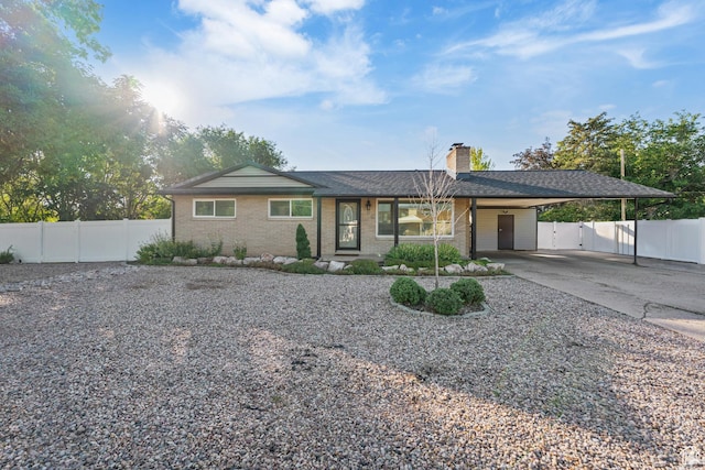 174 W Dawson St, Layton, UT 84041 - view of front of house featuring an attached carport, driveway, a gate, a chimney, and brick siding