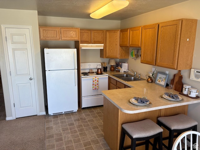 2896 W 3965 S Unit 86, West Haven, UT 84401 - kitchen with white appliances, under cabinet range hood, a peninsula, light countertops, and a breakfast bar area