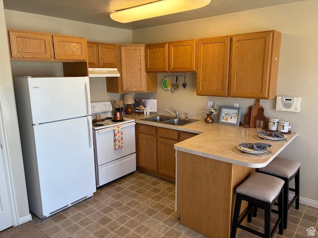 2896 W 3965 S Unit 86, West Haven, UT 84401 - kitchen with white appliances, under cabinet range hood, a peninsula, light countertops, and a kitchen breakfast bar