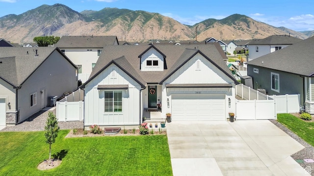 2456 W Maple St, Mapleton, UT 84664 - view of front of house featuring board and batten siding, a gate, concrete driveway, an attached garage, and a residential view