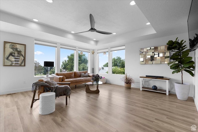 469 N 1360 E Unit 13, Tooele, UT 84074 - living room with a ceiling fan, light wood-type flooring, a textured ceiling, recessed lighting, and a raised ceiling