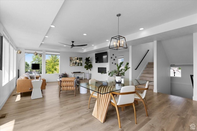 469 N 1360 E Unit 13, Tooele, UT 84074 - dining room featuring a fireplace, stairway, light wood-type flooring, recessed lighting, and a raised ceiling