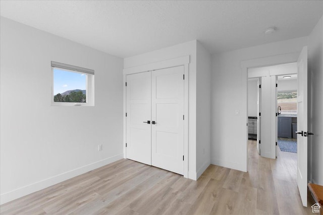 469 N 1360 E Unit 13, Tooele, UT 84074 - unfurnished bedroom featuring light wood-style floors and a closet