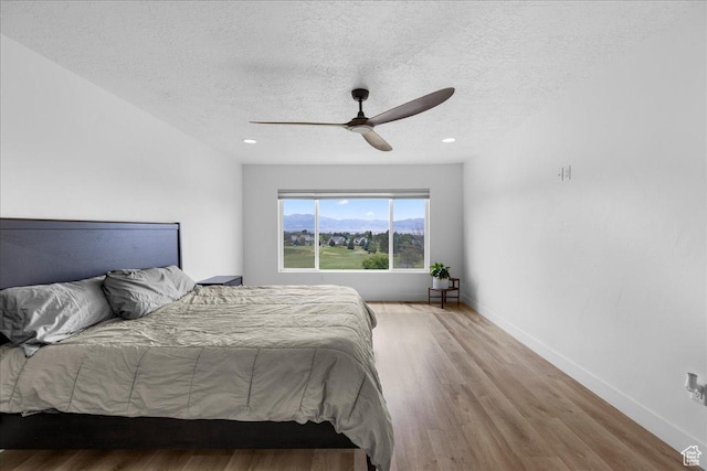 469 N 1360 E Unit 13, Tooele, UT 84074 - bedroom featuring a textured ceiling, wood finished floors, and a ceiling fan