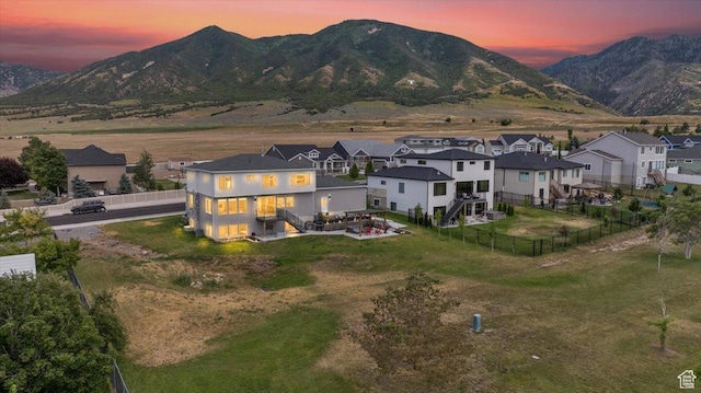 469 N 1360 E Unit 13, Tooele, UT 84074 - back of property at dusk with a fenced backyard, a mountain view, and a residential view