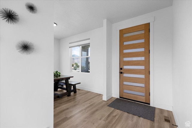 469 N 1360 E Unit 13, Tooele, UT 84074 - entryway with light wood-style floors and a textured ceiling