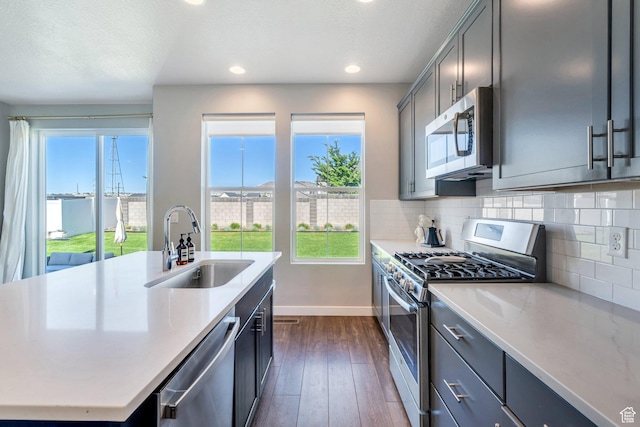 2739 N 3550 W, Lehi, UT 84043 - kitchen featuring stainless steel appliances, dark wood finished floors, light countertops, healthy amount of natural light, and recessed lighting