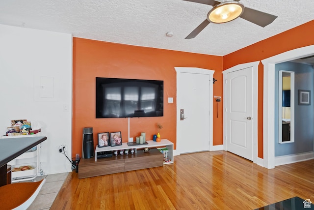 555 E 100 S Unit 206, Salt Lake City, UT 84102 - living room featuring a ceiling fan, wood finished floors, and a textured ceiling