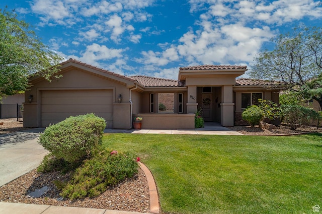 960 N Catalpa Dr, Washington, UT 84780 - mediterranean / spanish house featuring a tile roof, an attached garage, stucco siding, and concrete driveway