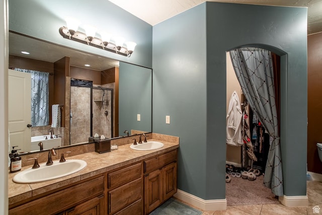 960 N Catalpa Dr, Washington, UT 84780 - full bathroom with a shower stall, double vanity, a garden tub, and tile patterned floors
