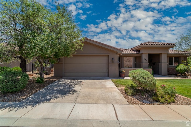 960 N Catalpa Dr, Washington, UT 84780 - view of front of home featuring a garage, a tile roof, driveway, and stucco siding