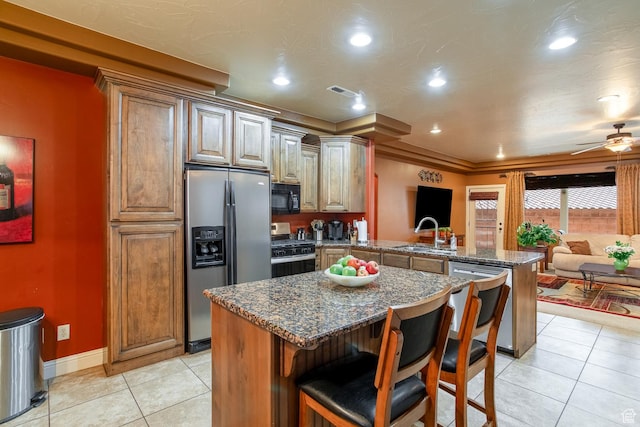 960 N Catalpa Dr, Washington, UT 84780 - kitchen featuring stainless steel appliances, a peninsula, light tile patterned floors, ceiling fan, and a kitchen bar
