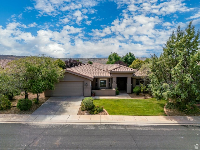 960 N Catalpa Dr, Washington, UT 84780 - mediterranean / spanish-style home with a tile roof, a garage, stucco siding, driveway, and a front lawn