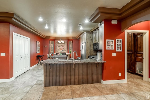 960 N Catalpa Dr, Washington, UT 84780 - kitchen featuring black microwave, freestanding refrigerator, a peninsula, dark stone countertops, and light tile patterned flooring