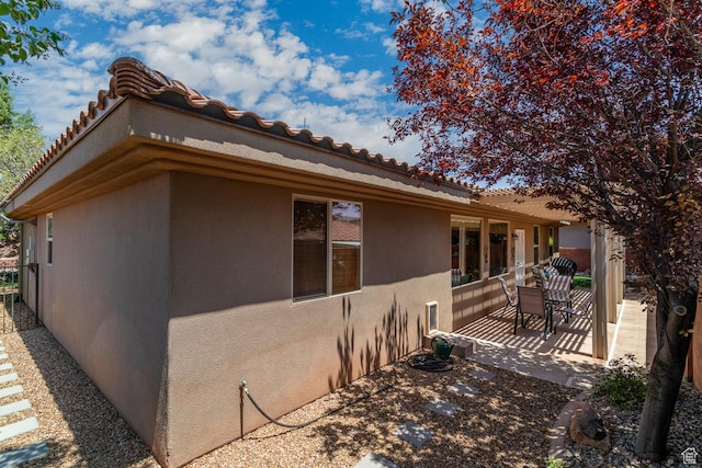 960 N Catalpa Dr, Washington, UT 84780 - view of side of property featuring stucco siding, a patio area, and a tile roof