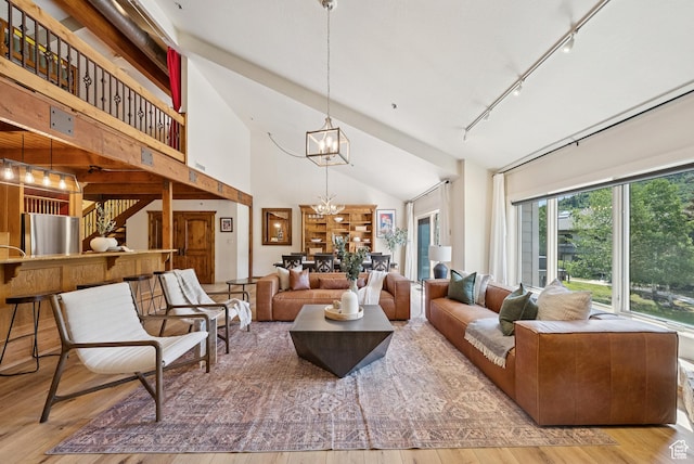 1582 Deer Valley Dr N, Park City, UT 84060 - living area with rail lighting, a chandelier, high vaulted ceiling, and hardwood / wood-style flooring