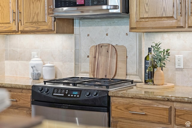 1582 Deer Valley Dr N, Park City, UT 84060 - kitchen with gas stove, decorative backsplash, brown cabinets, and light stone countertops
