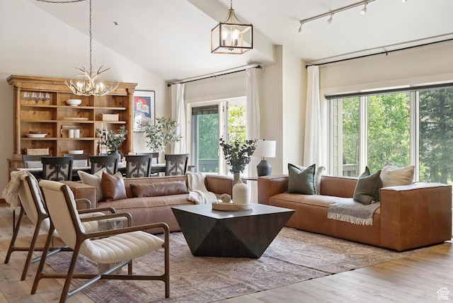 1582 Deer Valley Dr N, Park City, UT 84060 - living area featuring a chandelier, hardwood / wood-style flooring, track lighting, and high vaulted ceiling