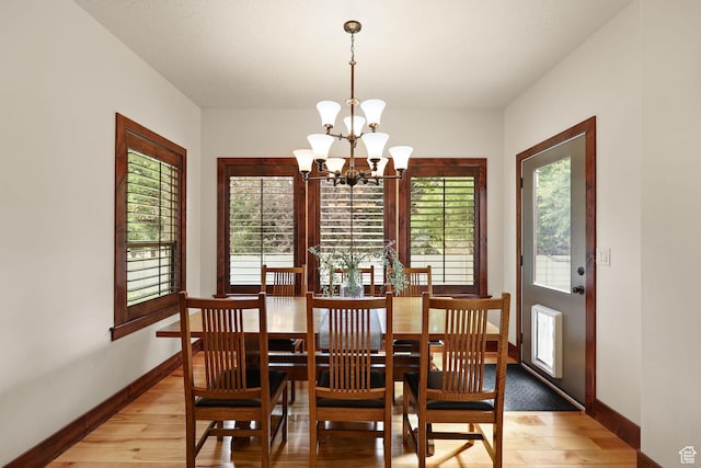 4048 W Ivy Ave, Mountain Green, UT 84050 - dining space with light wood finished floors, a chandelier, and healthy amount of natural light
