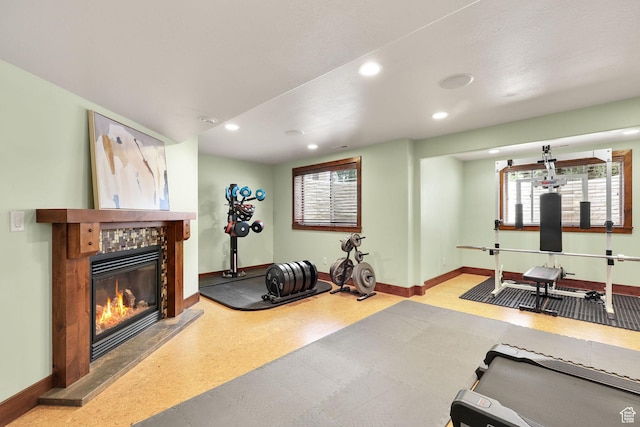 4048 W Ivy Ave, Mountain Green, UT 84050 - exercise room with a tiled fireplace, recessed lighting, and plenty of natural light