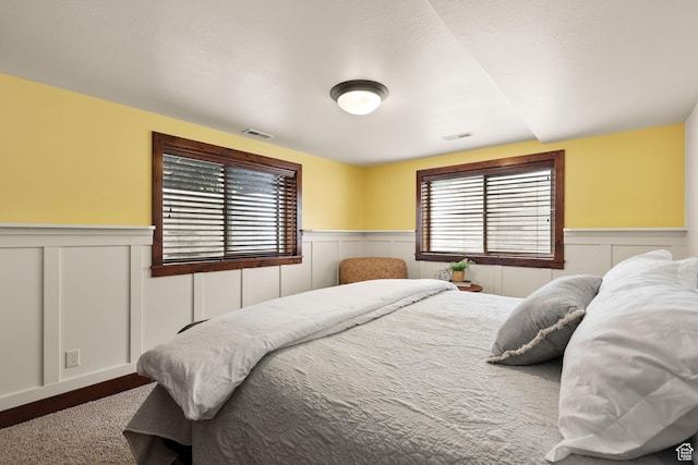 4048 W Ivy Ave, Mountain Green, UT 84050 - carpeted bedroom featuring wainscoting and a decorative wall