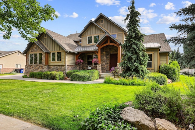 4048 W Ivy Ave, Mountain Green, UT 84050 - craftsman-style house featuring board and batten siding, stone siding, a front lawn, and a shingled roof