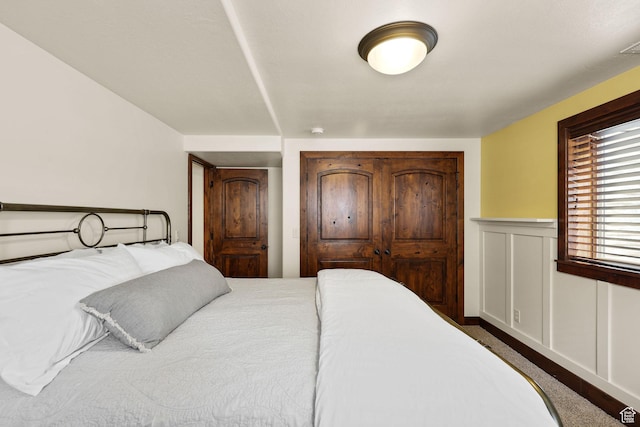 4048 W Ivy Ave, Mountain Green, UT 84050 - bedroom with a wainscoted wall and dark colored carpet