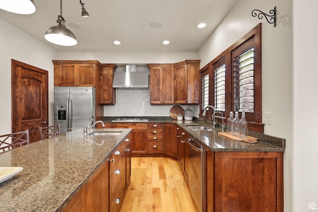 4048 W Ivy Ave, Mountain Green, UT 84050 - kitchen with stainless steel appliances, wall chimney range hood, light wood-style flooring, brown cabinets, and recessed lighting