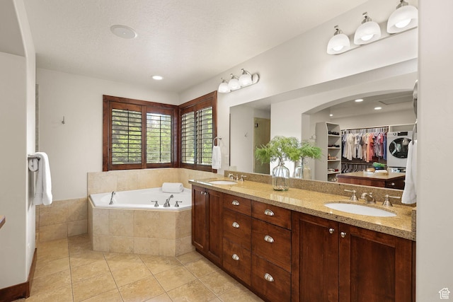 4048 W Ivy Ave, Mountain Green, UT 84050 - full bath with washer / dryer, a garden tub, tile patterned floors, double vanity, and a spacious closet