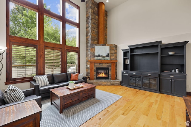 4048 W Ivy Ave, Mountain Green, UT 84050 - living room with a high ceiling, wood finished floors, and a stone fireplace