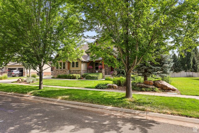 4048 W Ivy Ave, Mountain Green, UT 84050 - view of property hidden behind natural elements featuring stone siding and driveway
