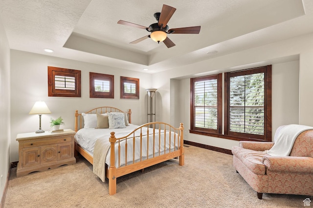 4048 W Ivy Ave, Mountain Green, UT 84050 - bedroom with light carpet, a tray ceiling, a ceiling fan, and recessed lighting