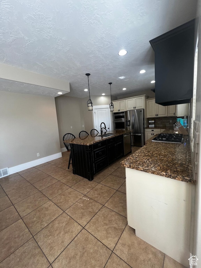1694 S 710 E, Lehi, UT 84043 - kitchen with stainless steel appliances, recessed lighting, dark stone countertops, light tile patterned floors, and hanging light fixtures