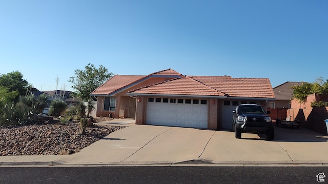 2054 E 140 S, St George, UT 84790 - view of front of property featuring a garage, a tiled roof, driveway, and stucco siding