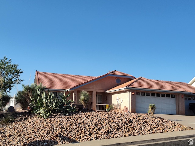 2054 E 140 S, St George, UT 84790 - ranch-style home with a tiled roof, an attached garage, driveway, and stucco siding