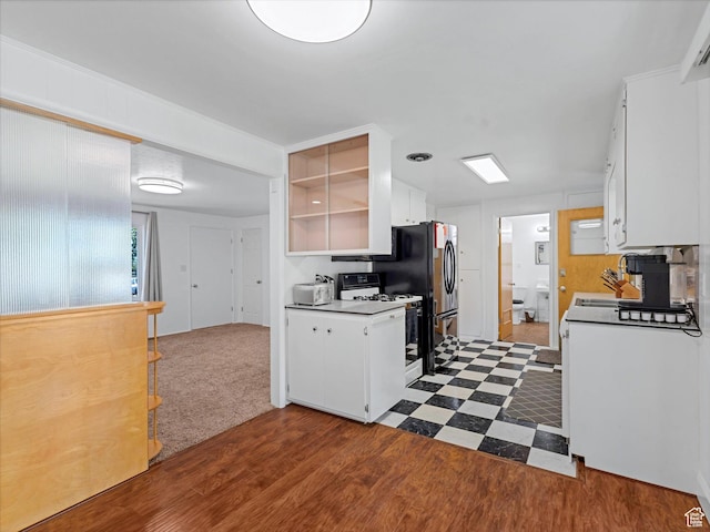 7645 W Gardenia Ave, Magna, UT 84044 - kitchen featuring white gas range oven, white cabinets, dark wood-style flooring, and open shelves