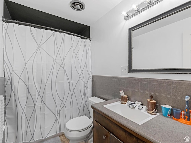 7645 W Gardenia Ave, Magna, UT 84044 - bathroom with vanity, curtained shower, tile walls, and wainscoting