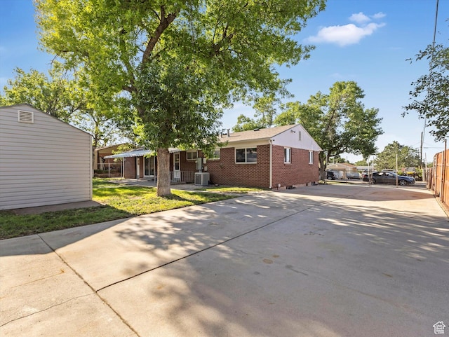 7645 W Gardenia Ave, Magna, UT 84044 - rear view of property featuring brick siding and concrete driveway